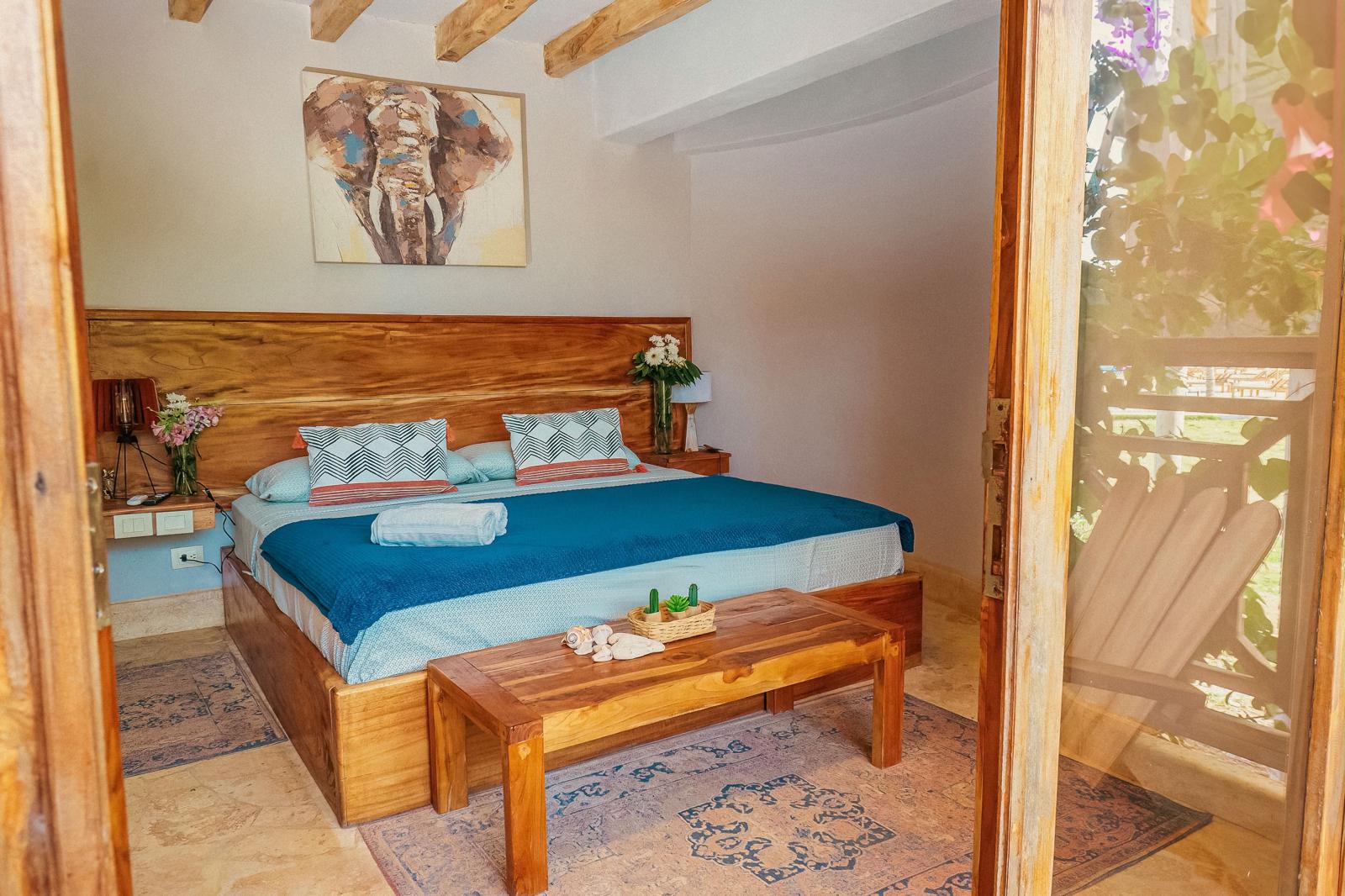 Bright suite with teak headboard and artisan textiles